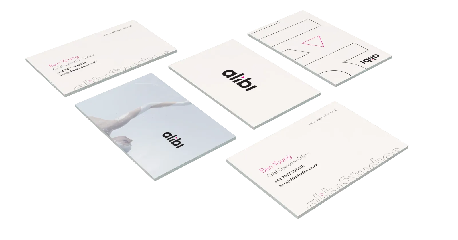 Alibi Studios business cards in white with pink and black details